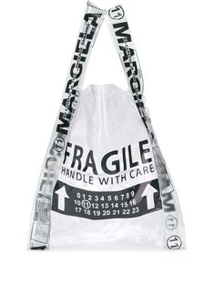 As always, handle Maison Margiela with care. Crafted in Italy, this transparent PVC shopper tote bag is printed with a 'Fragile' slogan on the front. We don't mind whether you put things in it or not. Featuring a sheer construction, top handles, an open-top design and a 'fragile' print. | Maison Margiela Fragile shopper tote Totes Ideas, Designer Totes, Zuhair Murad, Eco Bag, Paris Hilton, Shopper Tote, Jil Sander, Diy Bag, Tote Bag Design