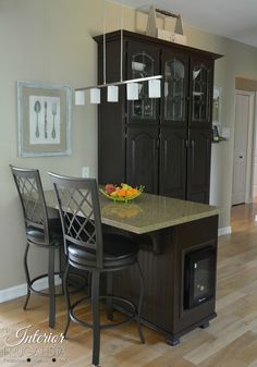 a kitchen with an island and chairs in it