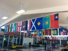 flags hanging from the ceiling in an airport