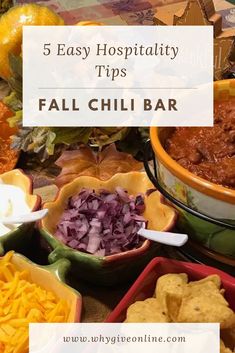 several bowls filled with chili and cheese on top of a table