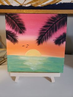 a painting of palm trees and the ocean at sunset