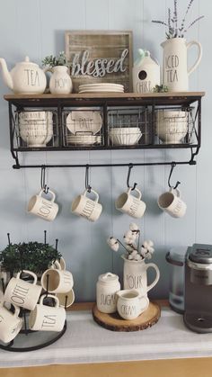 coffee mugs and teapots are displayed on a shelf