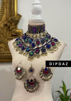 Exquisite Afghan Ethnic Jewelry - Handcrafted Tribal Elegance Original sets Explore the timeless beauty and intricate craftsmanship of our Afghan ethnic jewelry collection at Dipdaz. Each piece in our collection is a unique work of art, meticulously handcrafted by skilled artisans using traditional techniques passed down through generations. Our jewelry features a stunning array of vibrant gemstones, intricate metalwork, and authentic tribal designs, making every piece a true statement of cultur Ceremonial Multicolor Metal Jewelry, Bohemian Ceremonial Sets For Diwali, Bohemian Kundan Jewelry With Motifs, Bohemian Silver Jewelry Sets With Stone Work, Bohemian Jewelry For Diwali Ceremonial Occasion, Bohemian Jewelry For Ceremonial Occasions Like Diwali, Bohemian Jewelry For Diwali Ceremonies, Multicolor Motif Jewelry For Rituals, Ceremonial Multicolor Jewelry With Latkans