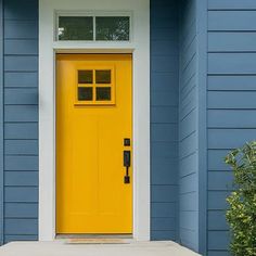 a yellow front door on a blue house