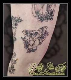 a woman's leg with tattoos on it and an image of a koala bear