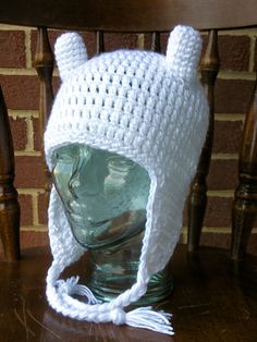 a white crocheted hat with ears on top of a head