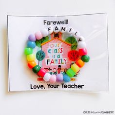 a colorful bracelet with the words love, your teacher written on it and an image of a house