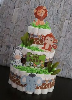 a three tiered cake decorated with jungle animals