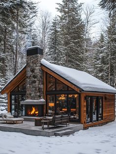 a cabin in the woods with snow on the ground