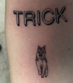 a tattoo that says trick with a cat on it