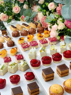 a table topped with lots of different types of desserts