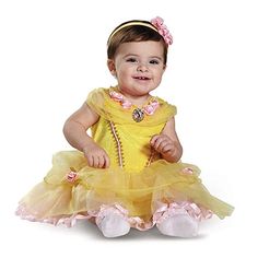 a baby girl dressed in a yellow dress