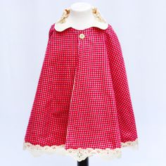 Here is our retro Little Red Riding Hood Cape! This adorable piece is more than just a garment; it's a portal to a bygone era, inspired by the vibrant 1960's mod style that has captivated generations. The cape boasts a unique floral Peter Pan collar, adding a touch of whimsical charm and elegance. Crafted from red and grey check fabric, this cape is not only visually stunning but also a statement of sustainable fashion. We pride ourselves on using vintage & pre-loved fabrics, ensuring that each Red Riding Hood Cape, Hood Cape, Costume Capes, 60's Style, The Art Of Storytelling, Mod Style, Check Fabric, Bygone Era, Mod Fashion