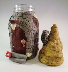 there is a vase with a house on it and a tree stump next to it