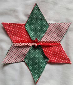 an origami star with green and red polka dots