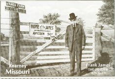 an old photo of a man in a suit and top hat standing next to a fence