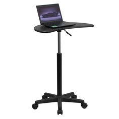 a laptop computer sitting on top of a black desk with wheels and casters,