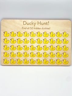 a wooden ducky hunt game with hundreds of rubber ducks on the front and sides