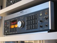 an analog radio sitting on top of a shelf