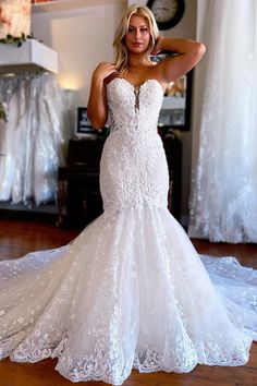 a woman in a wedding dress posing for the camera