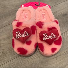 a pair of pink and red slippers with the word barbie written on them in heart - shaped letters