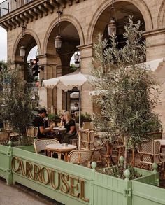 people sitting at tables in an outdoor cafe