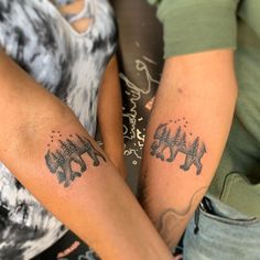 two people with matching tattoos on their arms