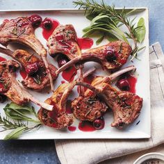 meat with cherries and herbs on a plate