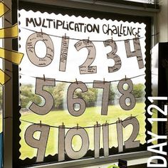 a window with numbers on it in front of a sign that reads, multiplection challenge