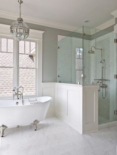 a white bath tub sitting next to a walk in shower