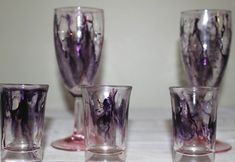 four glass cups sitting on top of a table