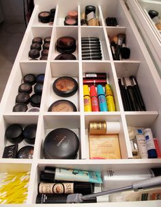 an organized drawer with makeup and other beauty products in the bottom section, including eyeshades