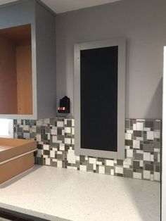 an empty bathroom with tiled walls and counter tops