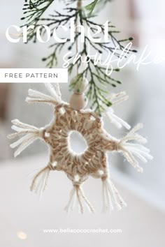 a crochet snowflake ornament hanging from a christmas tree branch