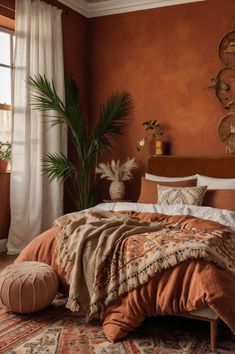 a bedroom with an orange wall and large potted plant