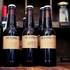 four bottles of wine sitting on top of a wooden table