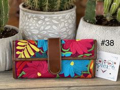 "This beautiful embroidered purse with traditional colorful flowers accents is perfect for any occasion. These purses are unique for their embroidered vibrant colors that add a bohemian look. It has a magnetic clip for closure and an additional pocket inside. Dimensions 8.5\" X 4\" More colors available here: https://www.etsy.com/es/listing/988769434/cartera-mexicana-con-bordado-floral?ref=listings_manager_grid" Everyday Embroidered Wallets, Embroidered Wallets For Daily Use, Traditional Multicolor Wallet For Everyday Use, Embroidered Wallets Perfect For Gifts, Daily Use Embroidered Rectangular Wallet, Traditional Multicolor Wallet, Traditional Embroidered Rectangular Wallets, Traditional Handmade Multicolor Wallets, Traditional Multicolor Handmade Wallets