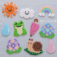 cross stitched magnets with different types of animals and flowers on them, all in the same pattern