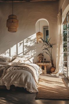 a bedroom with white walls and natural light coming through the windows