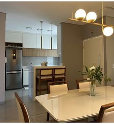 a dining room table with chairs and a vase on it