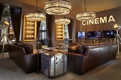 a living room filled with leather furniture and chandeliers