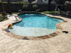 an empty swimming pool in the middle of a backyard