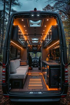 the interior of an rv with its lights on and couches in the back area