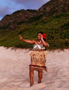 a woman standing on top of a sandy beach