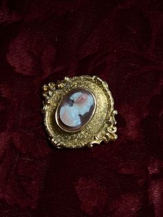 An adornment worthy of a museum! This stunning 19th century Sardonyx Cameo is a testament to Napoleon era French jewelry design. Crafted circa 1850-1860 in 18 carat gold, this brooch features a vibrant cameo of a aristocratic woman, set again a delicate peachy-hued sardonyx mount. The 18-carat gold mounting is also exceptional, with a gilded design brimming with fine detailing, and scrolling foliate motifs. The silhouette it creates makes it feel as if it should be hung in the halls of a palace! Elegant Yellow Gold Baroque Brooches, Yellow Gold Baroque Brooch For Formal Occasions, Formal Yellow Gold Baroque Brooches, Luxury Gold Brooches With Intricate Design, Antique Yellow Gold Collectible Brooches, Antique Yellow Gold Brooches Collectible, Victorian Brooches With Intricate Design, Victorian Brooches For Ceremonial Occasions, Luxury Intaglio Brooch For Formal Occasions