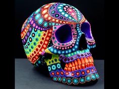 a brightly colored skull sitting on top of a table