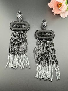 This is a beautiful Quirky beaded is Long and Oversized Beaded Earrings in Black and Silver tassel style design. Very light weight to wear and looks good on any attire. This is very beautiful to look at and a perfect one for regular wear and also parties.  Color : Black, Silver length : 6 inch width : 2 inch Each earring Weight : 5.9 grams Material : Beads, Fabric, Stone Beautiful High Quality, premium jewelry. Free US standard shipping. Hand crafted in India with the finest design, this earring Beaded Bohemian Chandelier Earrings For Party, Bohemian Beaded Chandelier Earrings For Party, Adjustable Beaded Chandelier Earrings For Party, Bohemian Fringe Chandelier Earrings For Party, Party Fringe Beaded Earrings With Round Beads, Party Beaded Fringe Earrings Adjustable, Party Beaded Earrings With Fringe And Round Beads, Beaded Fringe Chandelier Earrings For Party, Bohemian Beaded Earrings For Party