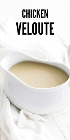 a close up of a bowl of soup on a table with the words chicken veloue above it