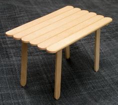 a small wooden table sitting on top of a carpet