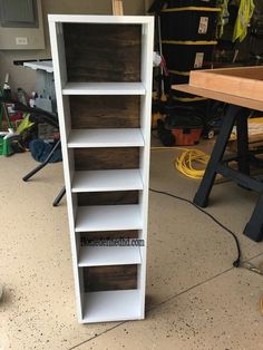 a white book shelf sitting inside of a garage